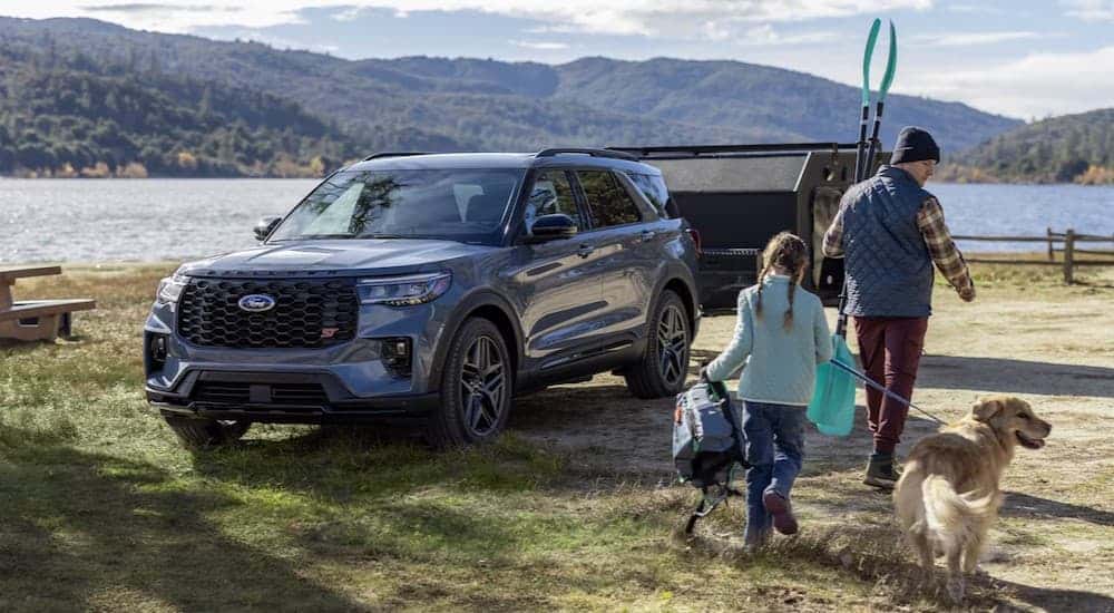 A family walking near a 2024 Ford Explorer ST-Line.