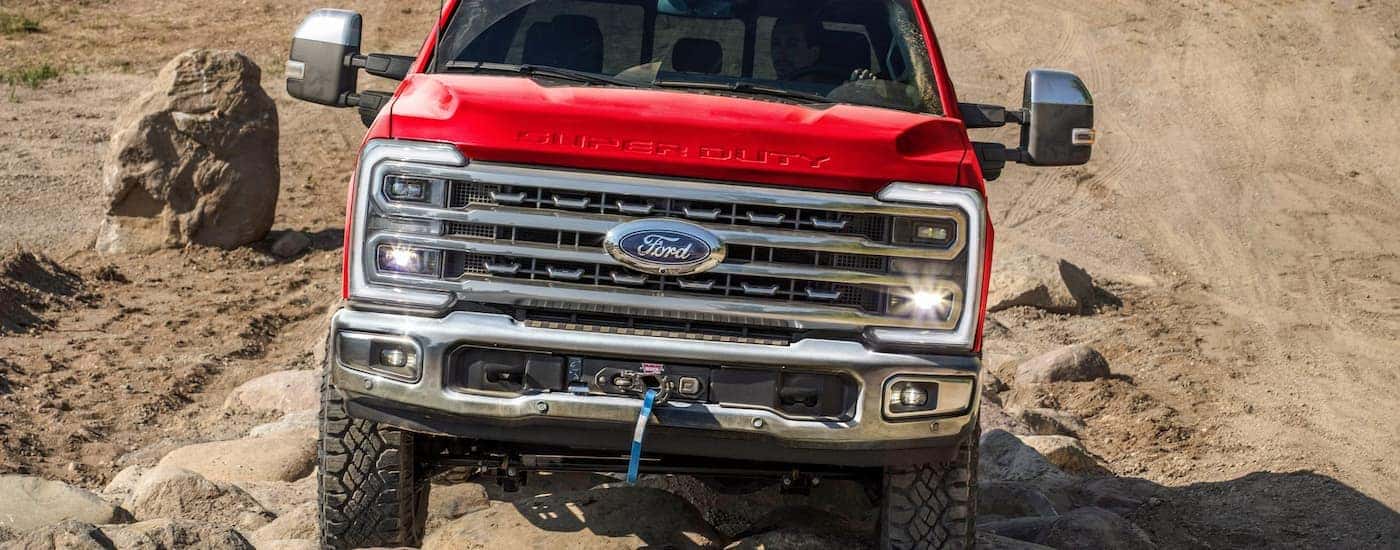 A red 2026 Ford Super Duty off-roading on sand