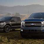 A black and a blue 2026 Ford F-150 park side by side