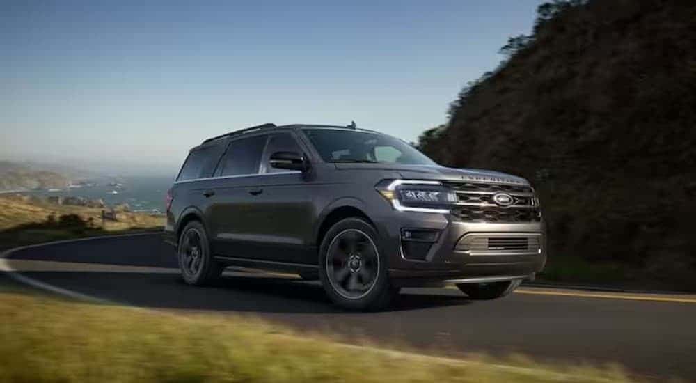 A gray 2024 Ford Expedition driving on a highway to view a used Ford for sale in Albany.
