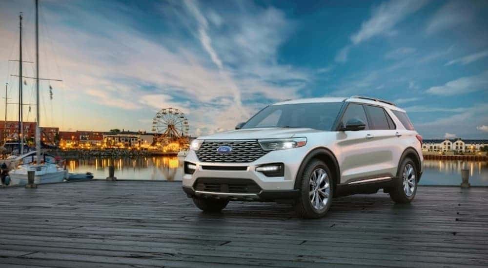 A white 2024 Ford Explorer parked on a dock.