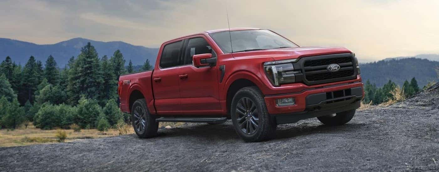 A red 2025 Ford F-150 Lariat parked from a dealership near North Adams