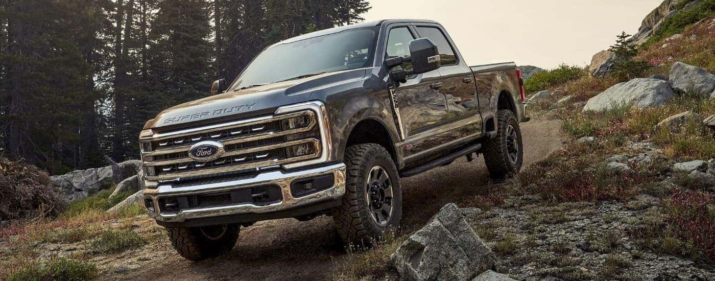A black 2025 Ford F-250 Tremor off-roading on a trail