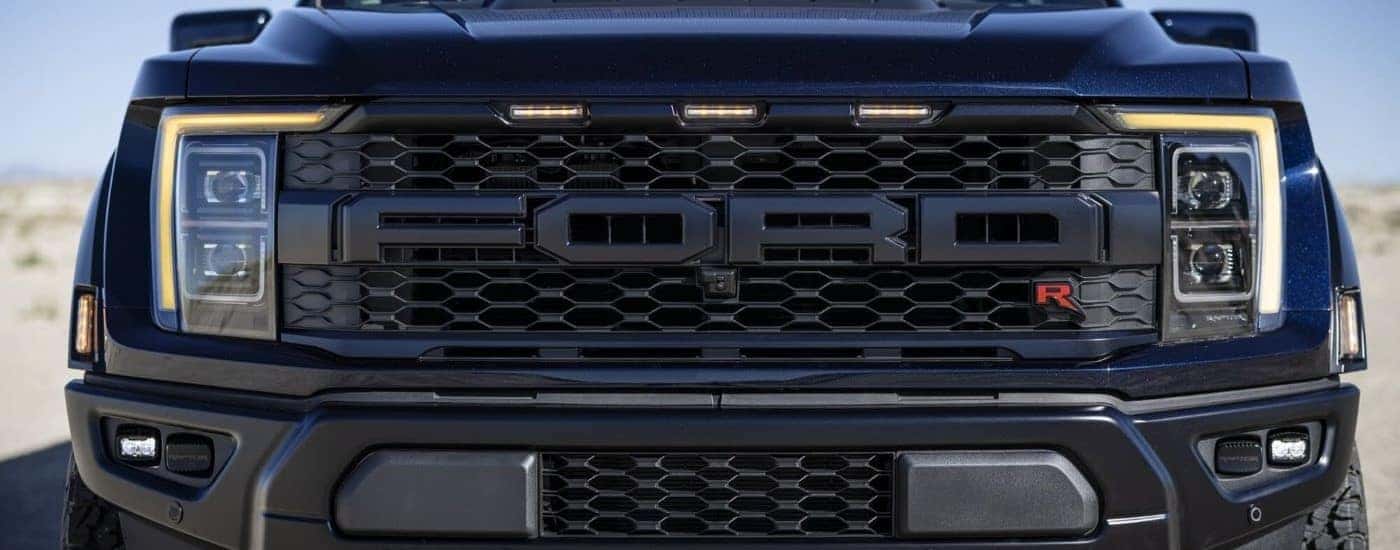 Front Ford logo on a black 2023 Ford F-150 Raptor