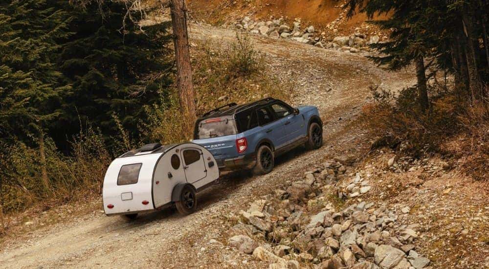 Blue 2026 Ford Bronco Sport Badlands towing a camper