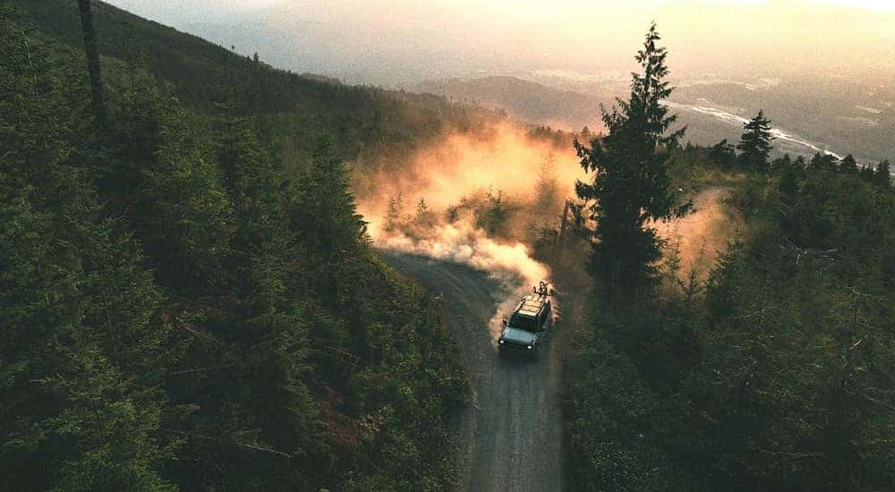 Silver 2026 Ford Bronco driving on a dusty trail