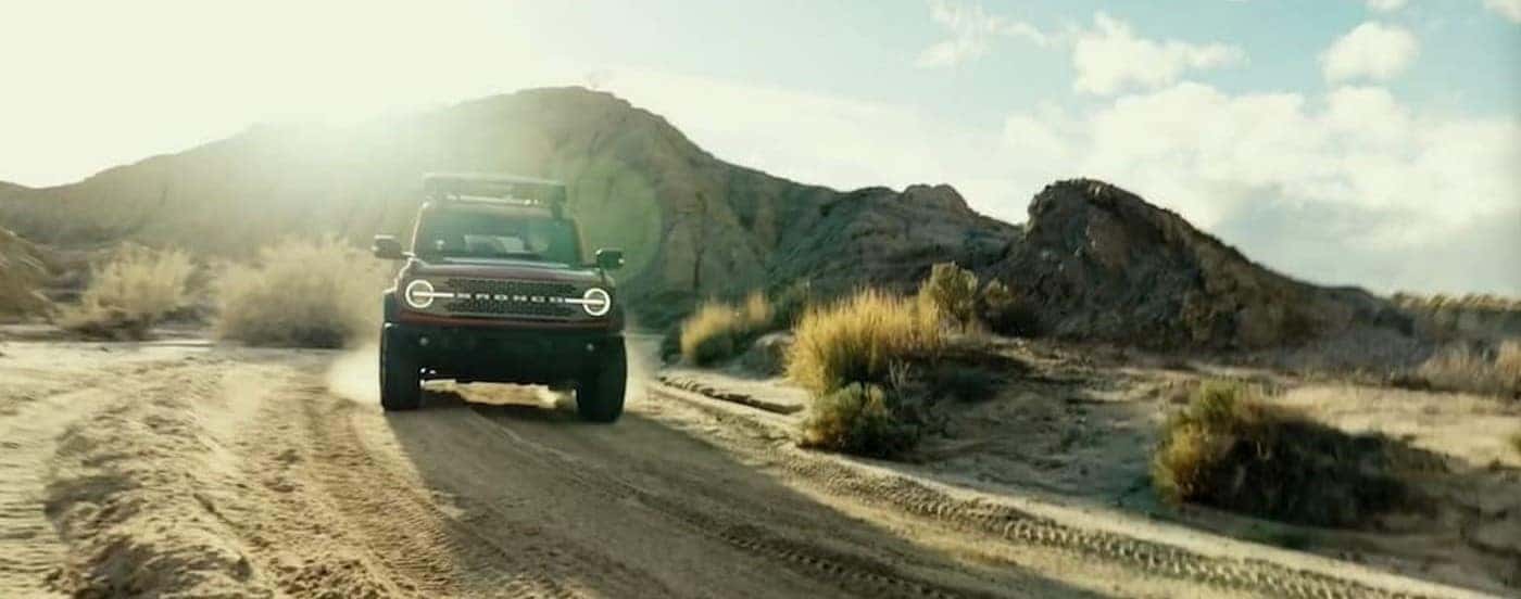 A red 2026 Ford Bronco off-roading.