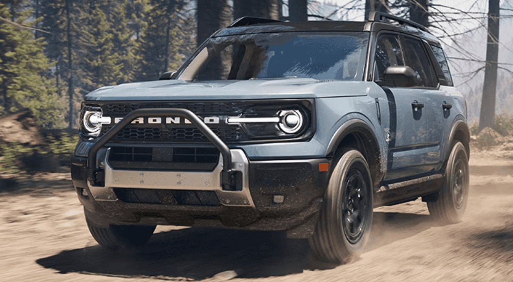 Blue 2026 Ford Bronco Sport driving along a trail
