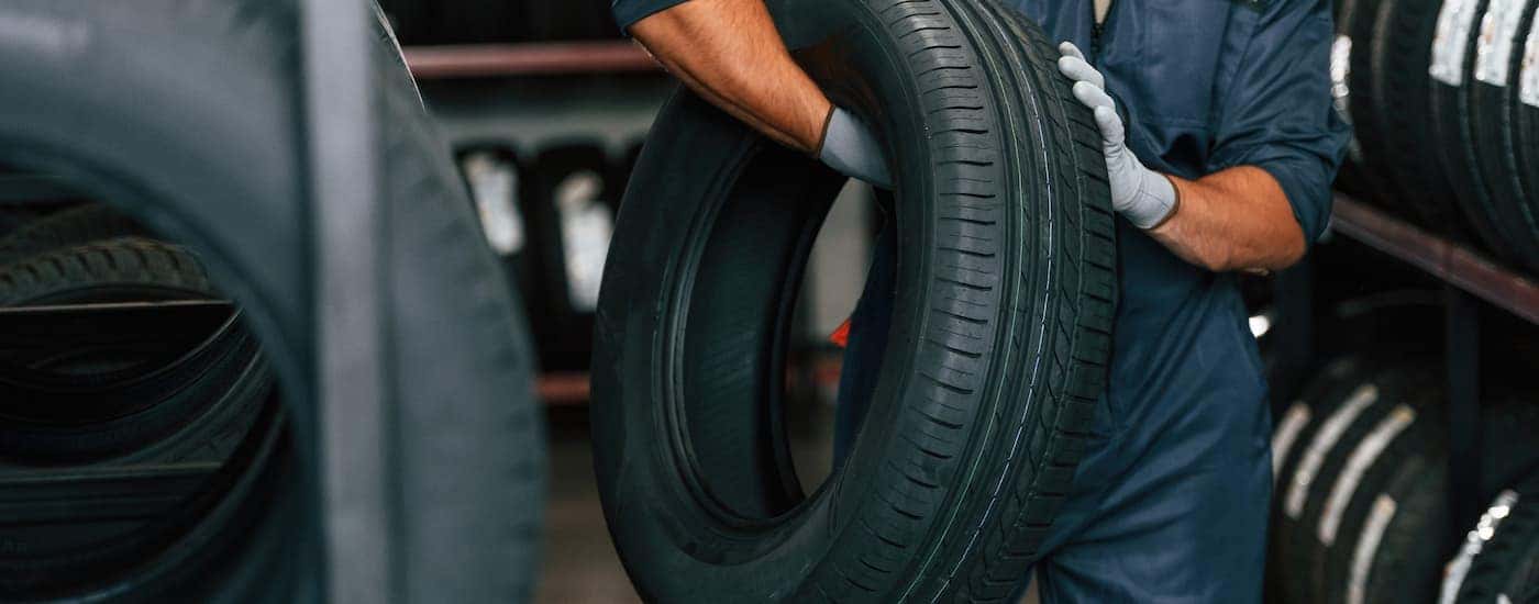 Mechanic carrying a tire