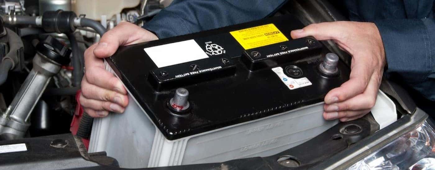 A technician installing a battery.