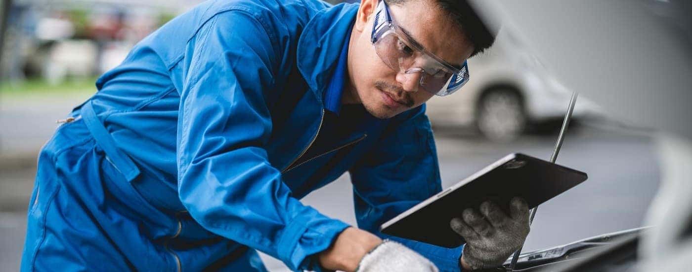 A mechanic inspecting an engine.