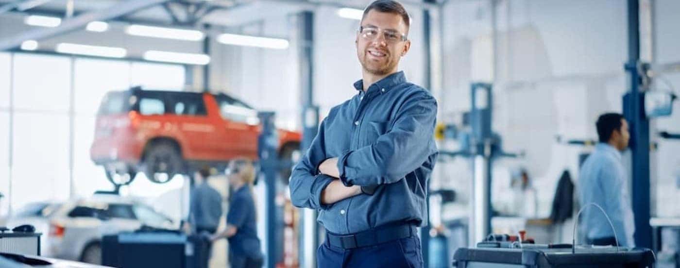 A technician standing in a garage bay.
