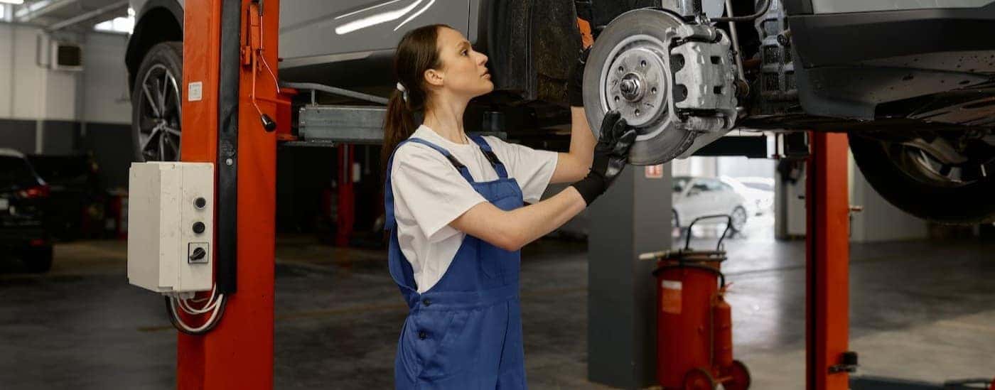 A mechanic inspecting brakes.