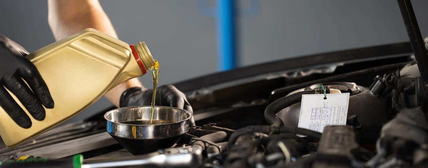 Oil being poured into a vehicle