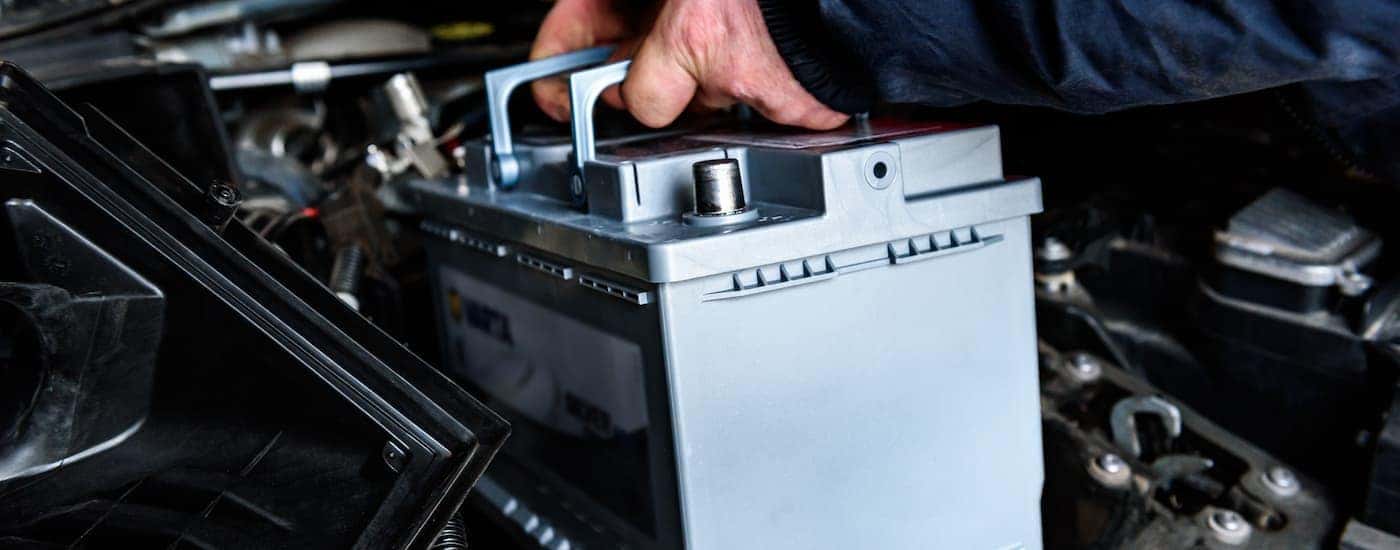 Mechanic replacing the battery on a vehicle