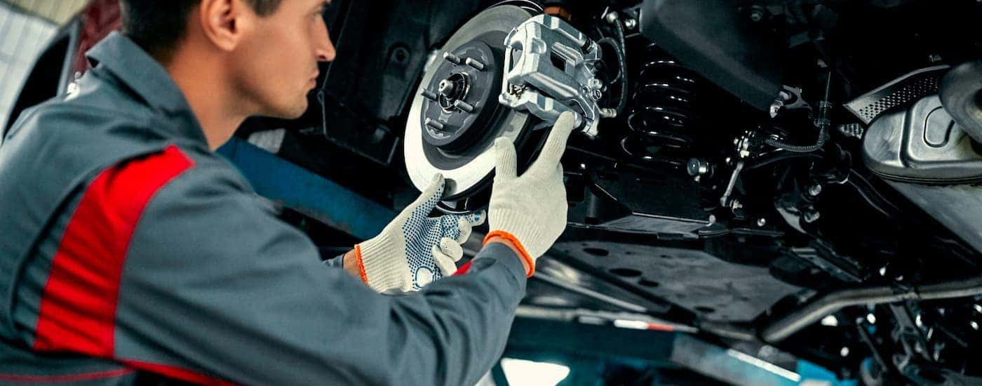 Mechanic replacing the brakes on a vehicle