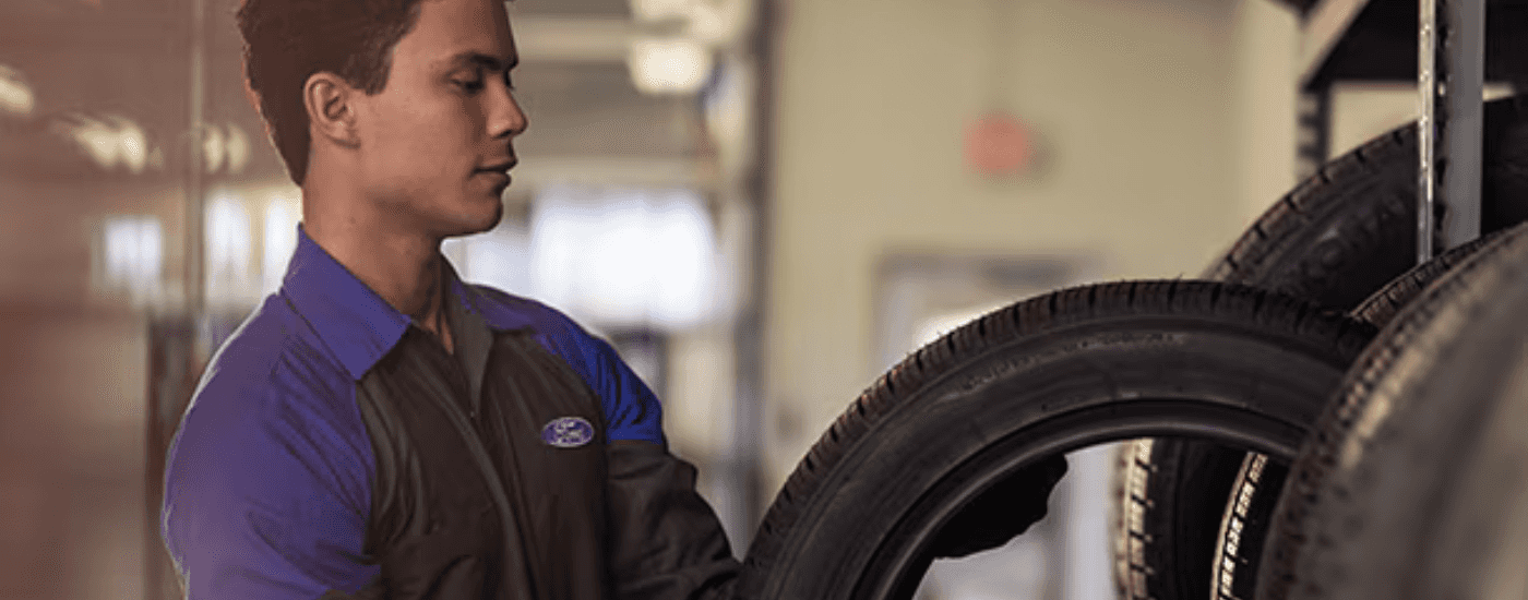 A ford technician getting a new set of tires