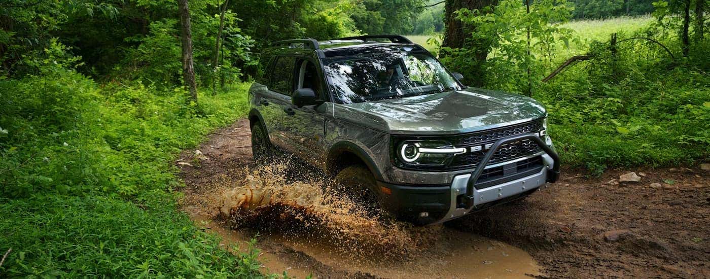 A gray 2026 Ford Bronco Sport off-roading in mud