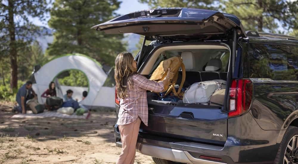 Black 2026 Ford Expedition MAX loaded cargo with tent campsite in background
