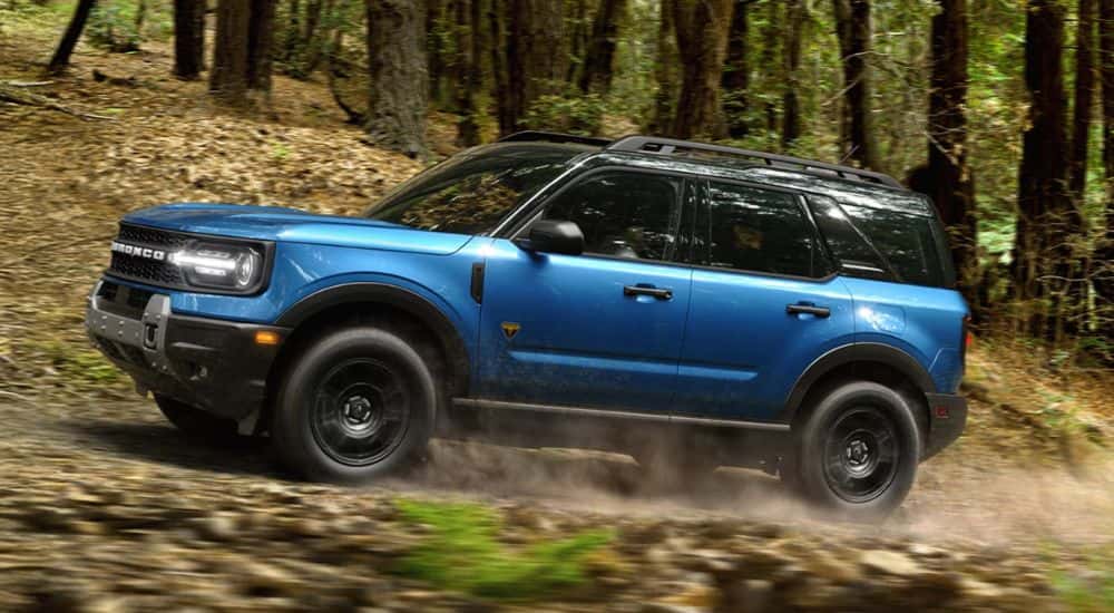 Blue 2026 Ford Bronco Sport driving through the woods
