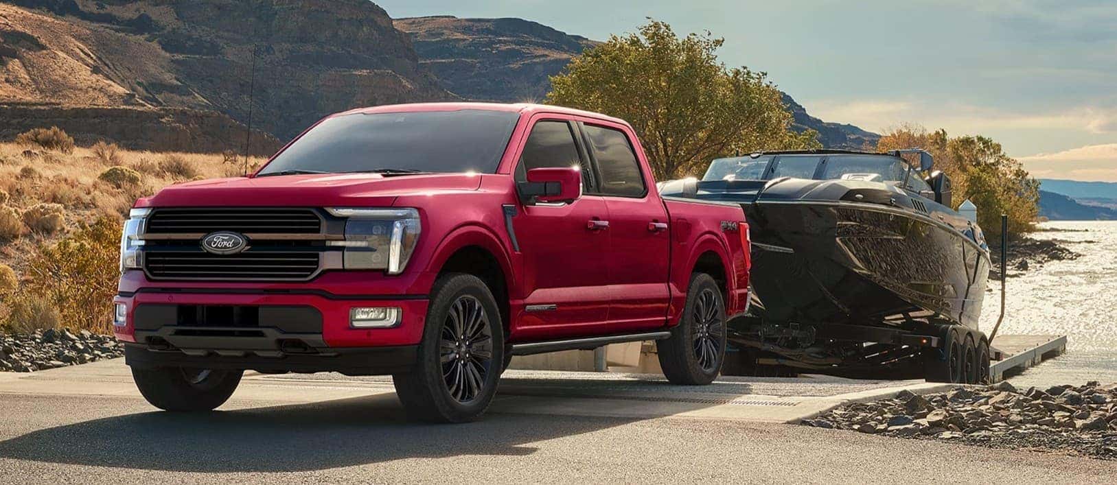 A red 2026 Ford F-150 towing a boat.
