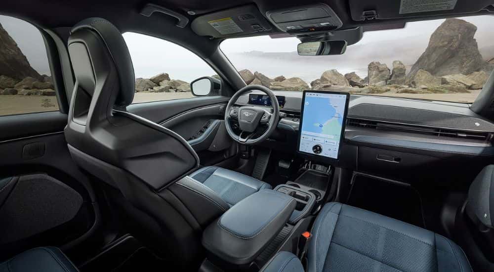 2026 Ford Mustang Mach-E SUV front dashboard in front of a rocky landscape