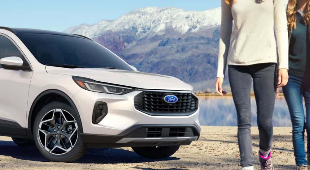 White 2026 Ford Escape parked near a lake with passengers leaving