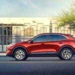Red 2020 Ford Escape driving down a city street
