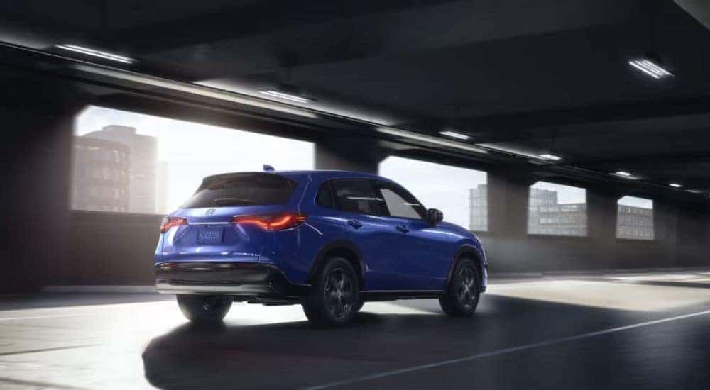 Blue 2023 Honda Hr-V driving through a parking garage
