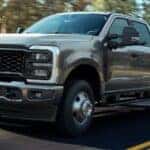 2026 Ford Super Duty® F-250® XL pickup with the STX® Appearance Package in Carbonized Gray driving on a paved road.