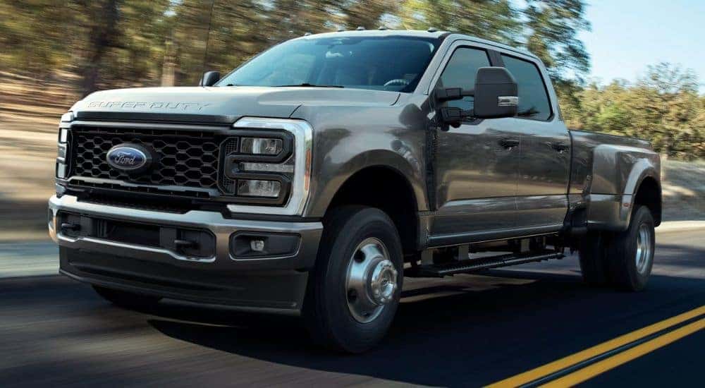 2026 Ford Super Duty® F-250® XL pickup with the STX® Appearance Package in Carbonized Gray driving on a paved road.