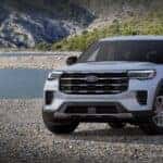 Silver 2026 Ford Explorer Active 100A parked on a rocky beach.