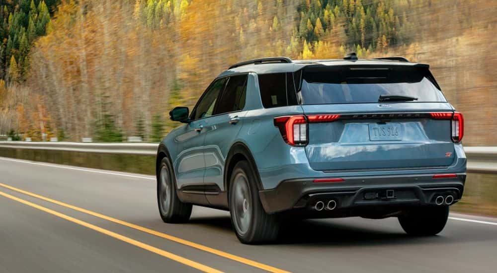 Blue 2026 Ford Explorer ST rear view on the road.
