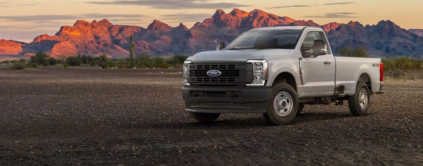White 2026 Ford F-250 parked with mountains in the background.