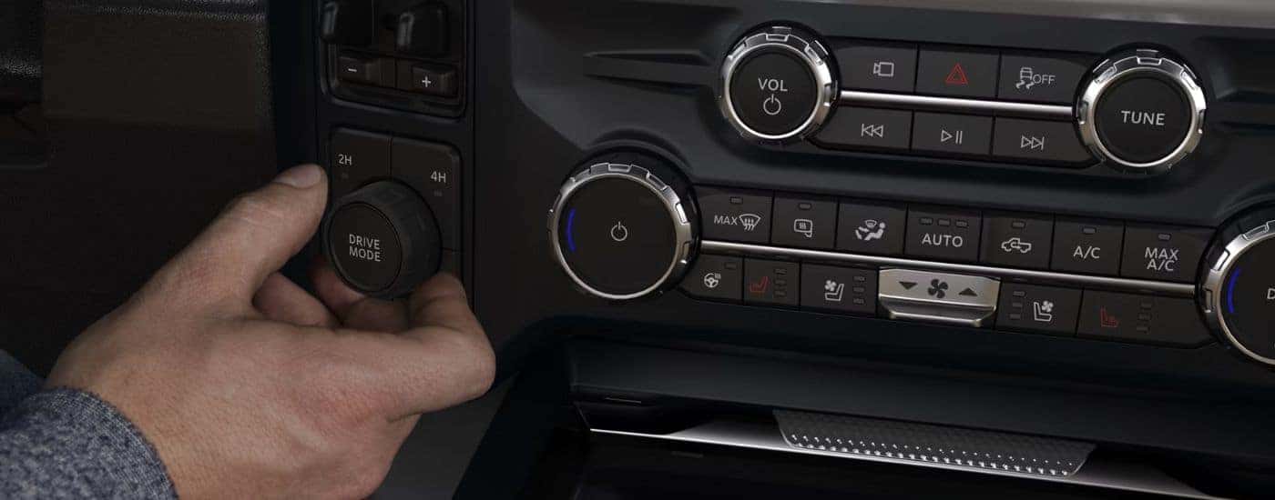 A person adjusting the Drive Mode knob on a 2026 Ford F-250.