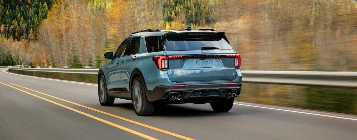 A blue 2026 Ford Explorer driving on a highway.