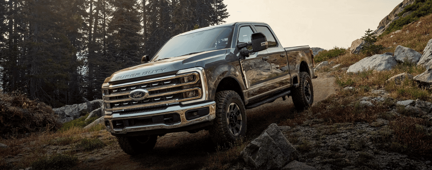 Grey 2026 Ford F-250 Super Duty driving down a hill
