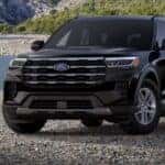 A black 2026 Ford Explorer Active is parked on a rocky beach.