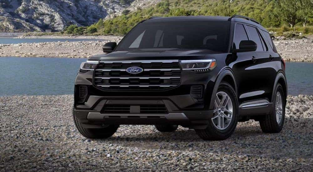 A black 2026 Ford Explorer Active is parked on a rocky beach.