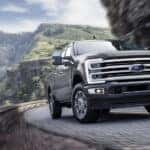 A gray 2026 Ford F-350 Platinum Plus turning a corner.
