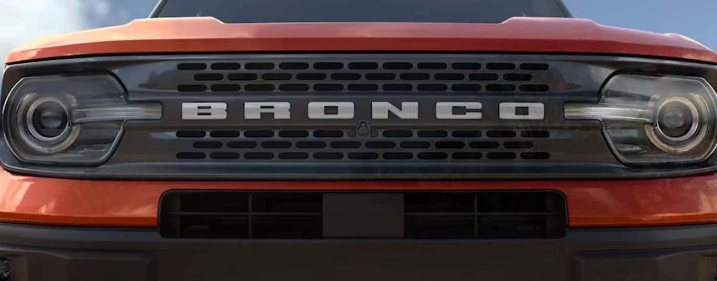 Front grille of an orange 2023 Ford Bronco Sport Badlands.