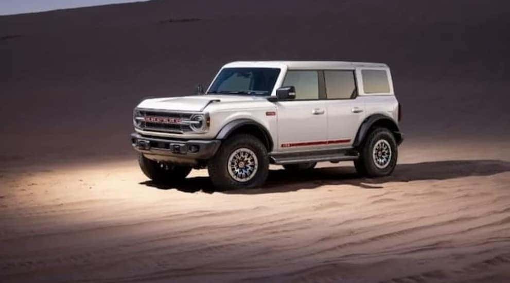 A white 2026 Ford Bronco Outer Banks parked offroad.