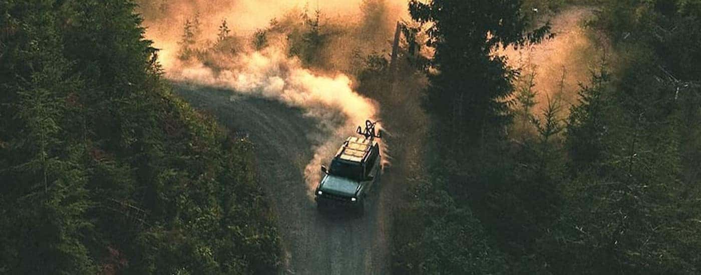 A blue 2026 Ford Bronco driving offroad.