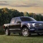 A blue 2023 Ford F-150 parked near a lake.
