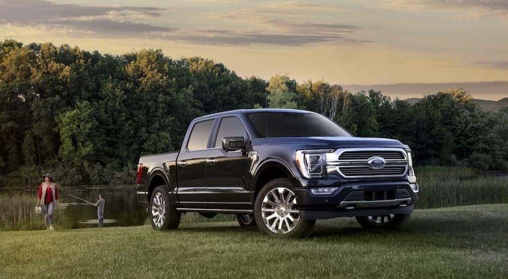 A blue 2023 Ford F-150 parked near a lake.