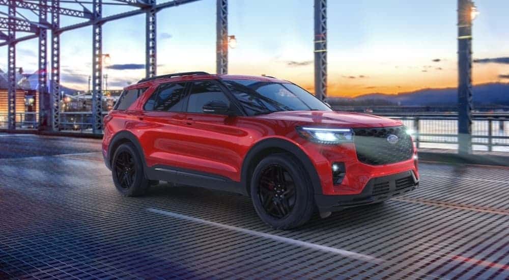 A red 2026 Ford Explorer ST driving on a bridge