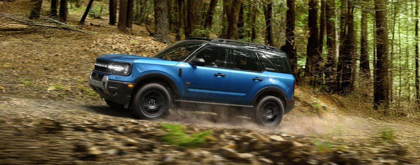 A blue 2026 Ford Bronco Sport Badlands driving off-road.