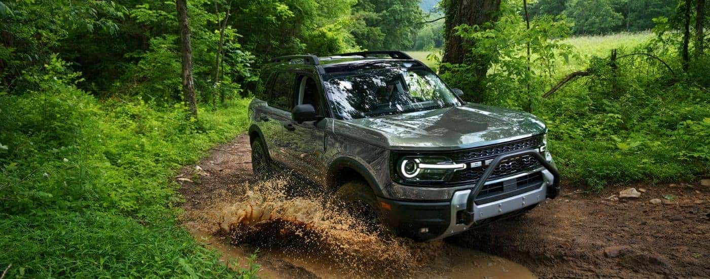 A gray 2026 Ford Bronco Sport driving a muddy trail.