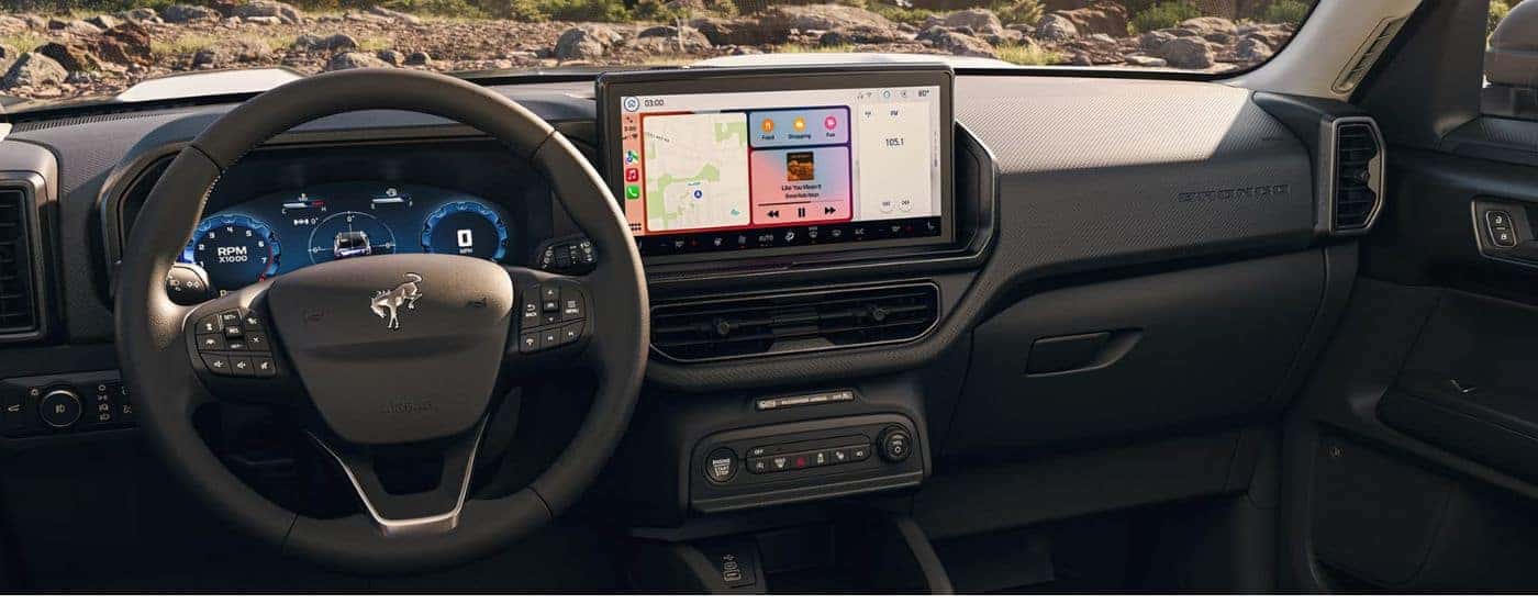 Infotainment display, steering, and digital gauge cluster in a 2026 Ford Bronco Sport.