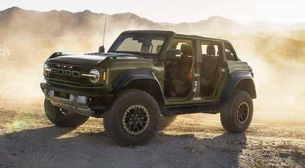 A green 2024 Ford Bronco Raptor parked offroad.